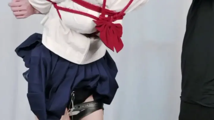 Asian teen spanked with paddle while bound in rope and metal