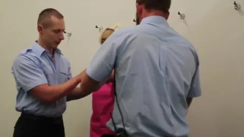 Blonde in jail cell stripped and searched by two tattooed dudes