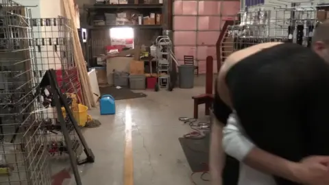 Blonde in black mask gets suspended and fucked in warehouse basement