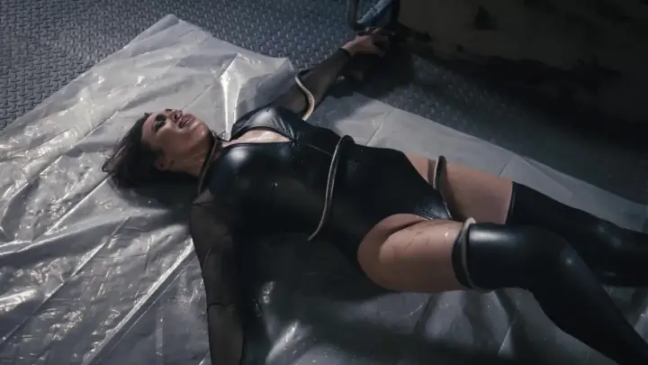 Brunette submissive fucked on plastic sheet in dim industrial room
