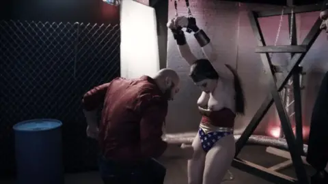 Indiscretion: Lily Lou Wonder Woman Costume Bondage Scene