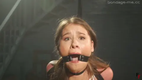 Patty Amazing – Standing Struggle with Crushed Elbows Tie and Ring Gag